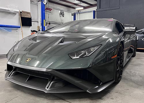 Lamborghini in the shop at Euromotion getting luxury car service, transmission service, engine repair. Best european garage in raleigh providing warranty on european car repairs in raleigh. Green sports car in european auto repair shop from trained technicians.