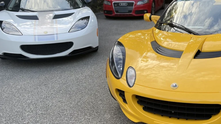 Yellow and white Lotus sports cars parked together