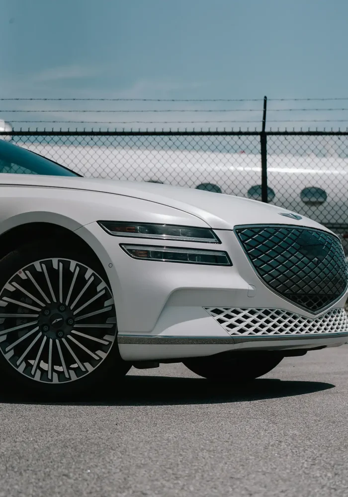 Close-up front view of a white Genesis luxury sedan